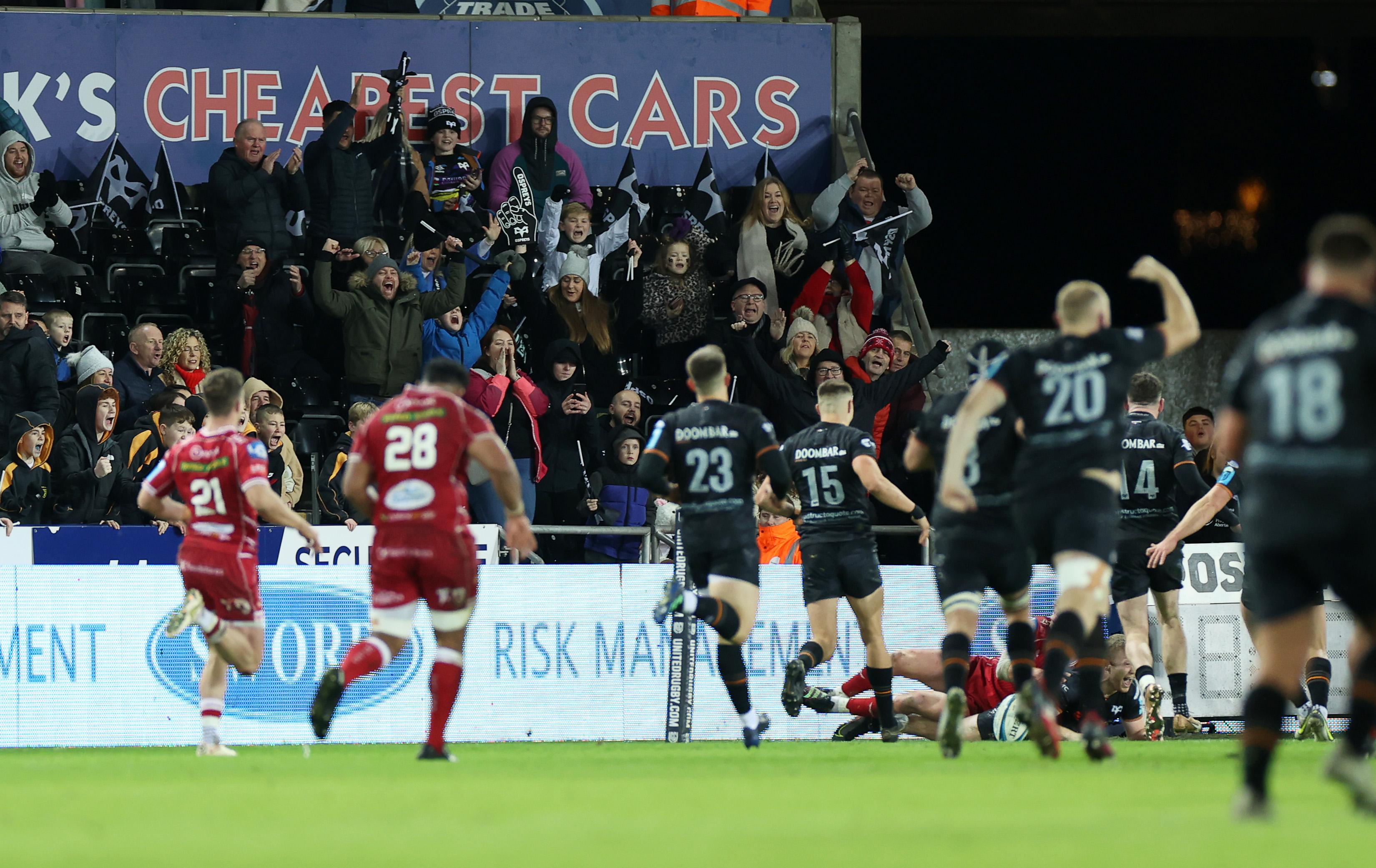 Ospreys celebrate a score over rivals Scarlets at the Swansea.com stadium