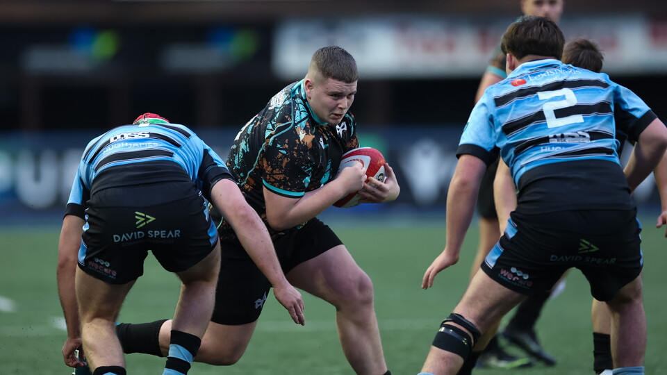 Mason James of Ospreys carries against Cardiff