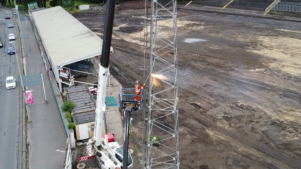 A man halfway of the flodlights cuts the metal as St helen's iconic flodlights are taken down during Ospreys' historic redevelopment of the ground  