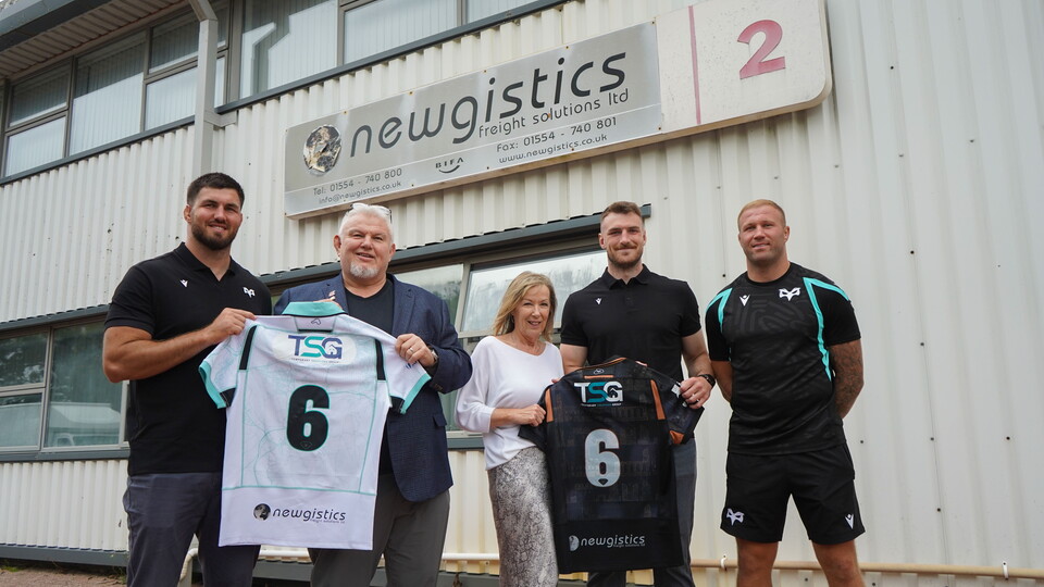 Liam Wright, James Ratti and Ross Moriarty stand for a photo with jon and Sue Newington, owners of Newgistics outside of their base 