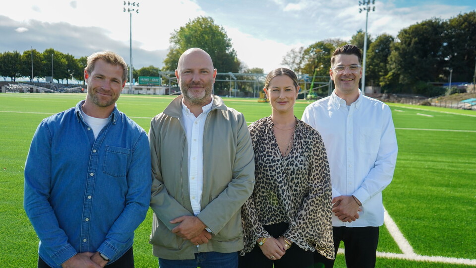 The Secret Hospitality group pose for a photo on St Helen's pitch with Ospreys' Liam Dobell 